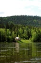 Izba on the Siberian mountain taiga and river Mana Royalty Free Stock Photo