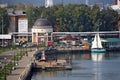 Izhevsk, Republic of Udmurtia, Russia - 08.16.2022. Chapel of Catherine the Great Martyr, sailboat and industrial buildings of the