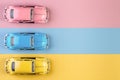 Izhevsk, Russia, February 15, 2020. Small vintage retro toy cars on a pink, yellow and blue background Royalty Free Stock Photo