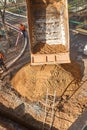 Izhevsk, Russia - May 08 2021: Truck pours out soil near trench with ladder at pipeline repair