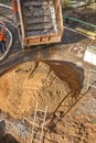 Izhevsk, Russia - May 08 2021: Truck pours out soil near trench with ladder at pipeline repair