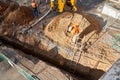 Izhevsk, Russia - May 08 2021: Skilled workers bury deep trench during lying new pipeline