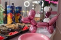 Sushi set, rolls with ginger and wasabi, drinks on background. Pink balloon dog or puppy. Party