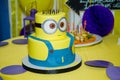 Birthday cake in minion shape. Cartoon character cake for child party. Thematic event. Candy bar