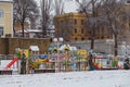 Izmail, Ukraine. February 2022. bright playground in the shape of a ship covered with snow. Empty winter city street