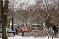 Izmail, Ukraine. February 2022. Janitors or sweepers cleaning city streets from snow with showels and brooms. Snow removal in