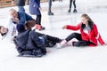 Izmail, Ukraine - February, 15, 2020: people fall on an ice rink. Ice skating.