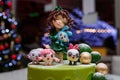 Izmail, Ukraine. January 2021. Beautiful green birthday cake with girl and Kikoriki or Smeshariki cartoon figures on top Royalty Free Stock Photo