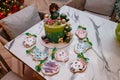 Izmail, Ukraine. January 2021. Gingerbreads, green birthday cake with girl and Kikoriki or Smeshariki cartoon figures on top Royalty Free Stock Photo