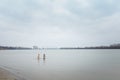 Two girls in water. Christening or baptism bathing in winter river. January rite, religious tradition or ritual of God believers