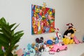 Different girlish cuddly toys on table, soft fabric stuffed animals in child baby girl room. Colorful