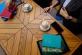 Izmail, Ukraine. May 2021. Colleagues having business lunch or coffee break. Female hands with tablet, smartphone, notebooks on