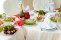 Festive table setting with salads, fruit and vegetable plates and beverages Royalty Free Stock Photo