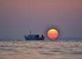 Izmir aliaga yenisakran bay fishermans in the boat and sun Royalty Free Stock Photo