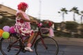 Woman riding a bicycle with baloons and fancy stuff in Izmir and on the day of Fancy Woman bike tour