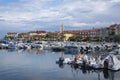 Izola  SLOVENIA - September 8  2019: Touristic view of Izola old fishing town historic center with church tower and marina Royalty Free Stock Photo