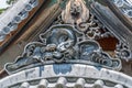 Detail of colored eye clay dragon gargoyle roof ornament at Shuzenji Temple