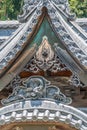 Detail of colored eye clay dragon gargoyle roof ornament at Shuzenji Temple