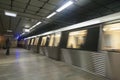 Subway train leaving the station and people waiting for the next one 