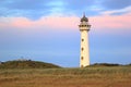 Lighthouse at sunset in the twilight. Egmond aan Zee, North Sea, the Netherlands.