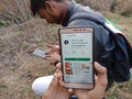 jabalpur, India - December 2019: photo people app displayed on smart phone screen with holded mobile