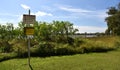 Caution plates alerting about dangerous predator at Lake Jabiru