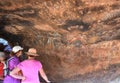 Tourist watching aboriginal rock drawings at Uluru Royalty Free Stock Photo