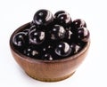 Jaboticaba in a basket on a white background. The jaboticaba or jabuticaba is a purplish black-white fruit, typical fruit of
