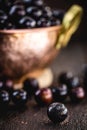 Jaboticaba or jabuticaba, Brazilian and South American fruit, in a copper pot on a rustic table. Fruit for medicinal and culinary