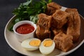 Jachnun or Jahnun, Yemenite Jewish pastry, served with fresh grated tomato and boiled egg and Zhug,