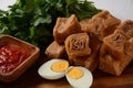 Jachnun or Jahnun, Yemenite Jewish pastry, served with fresh grated tomato and boiled egg and Zhug,