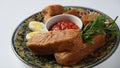 Jachnun or Jahnun, Yemenite Jewish pastry, served with fresh grated tomato and boiled egg and Zhug,