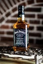 Jack Daniels whiskey bottle on an iron grating