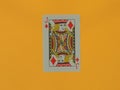 A Jack of Diamonds playing card on a yellow background. Royalty Free Stock Photo