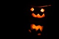 Jack Lantern isolated on black background. Close up view of scary halloween pumpkin with eyes and spooky reflection Royalty Free Stock Photo