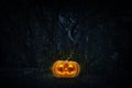 Jack O Lantern pumpkin on grass over spooky forest at night time Royalty Free Stock Photo