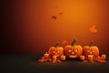 Jack O Lantern pumpkins, candles and leaves on orange background