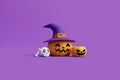 Jack-o-Lantern pumpkins wearing witch hat with skull and bone on purple background Royalty Free Stock Photo