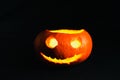 Jack-o-lanterns without cover, with a evil face on the black background Royalty Free Stock Photo