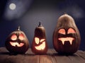 Jack o lanterns Halloween pumpkin face on wooden background Royalty Free Stock Photo