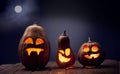 Jack o lanterns Halloween pumpkin face on wooden background Royalty Free Stock Photo