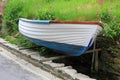 Jacked up rowing boat beside the street