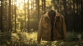 Jacket hanging on a hanger in a forest with sunlight filtering through trees Royalty Free Stock Photo