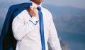 A jacket over his shoulder. The groom keeps his jacket Royalty Free Stock Photo