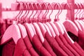 Jackets on hangers in the store, concept of color year 2023 Viva Magenta.