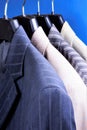 Jackets from suit men`s choice on the hanger in the store. Jacket in the wardrobe of men - decoration, accessory, business clothe