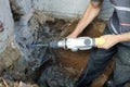 Jackhammer in action, pneumatic construction tool, drilling a hole in the concrete wall Royalty Free Stock Photo