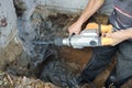 Jackhammer in action, pneumatic construction tool, drilling a hole in the concrete wall Royalty Free Stock Photo