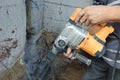 Jackhammer in action, pneumatic construction tool, drilling a hole in the concrete wall Royalty Free Stock Photo