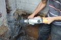 Jackhammer in action, pneumatic construction tool, drilling a hole in the concrete wall Royalty Free Stock Photo